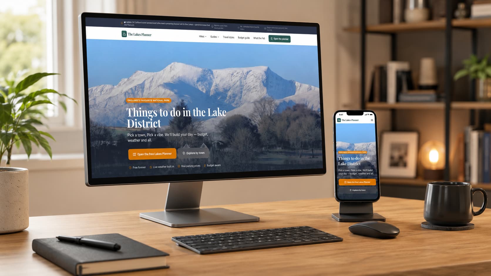 The Lakes Planner website shown on a desktop monitor and phone in a home office
