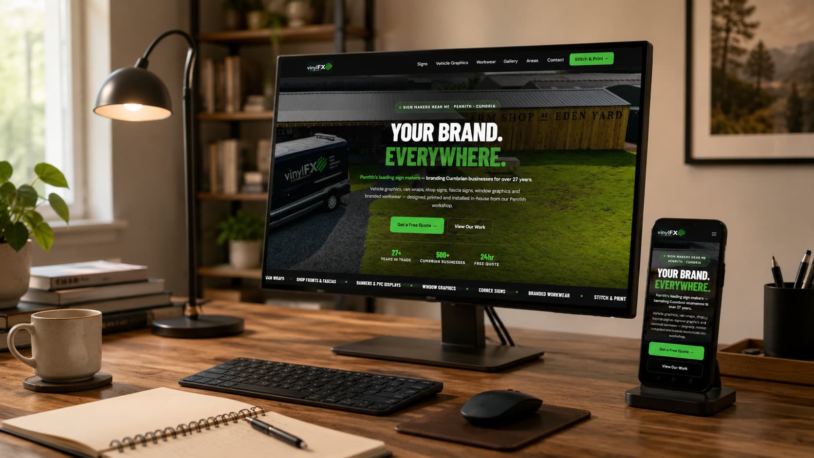 Vinyl FX sign makers website shown on a desktop monitor and phone in a home office